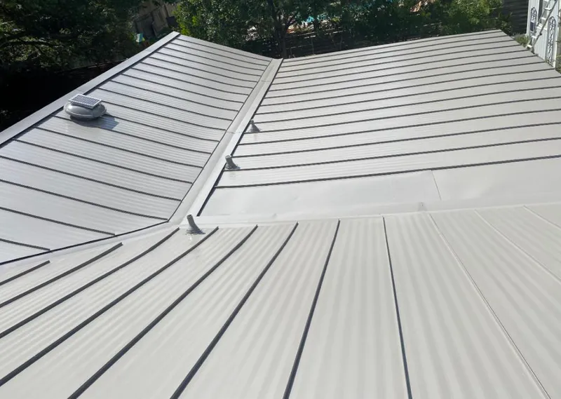 Solar attic fan installed on a metal roof for Roof Ventilation in Ewa Gentry